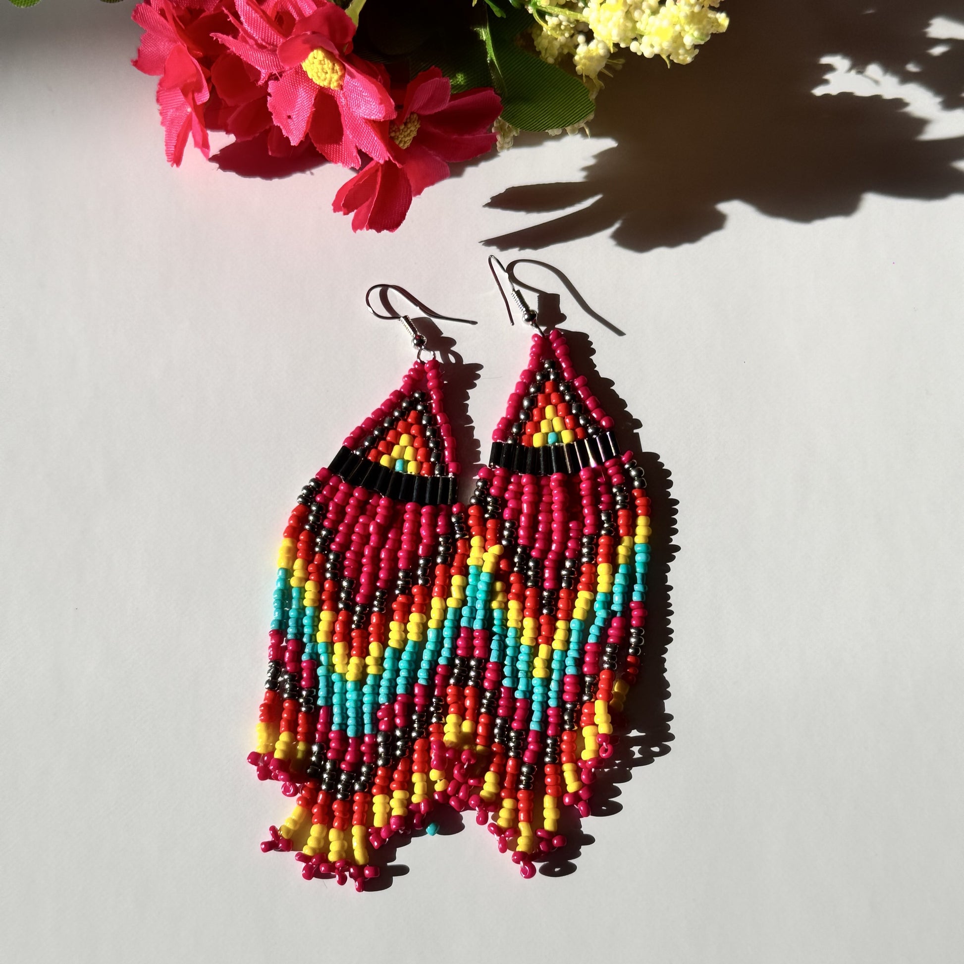 Elevate your style with these&nbsp;beaded earrings, a perfect blend of vibrant colors and intricate craftsmanship. Designed for bold, confident individuals, these statement earrings are inspired by traditional beadwork, featuring a chevron zigzag pattern that adds a unique artistic touch.