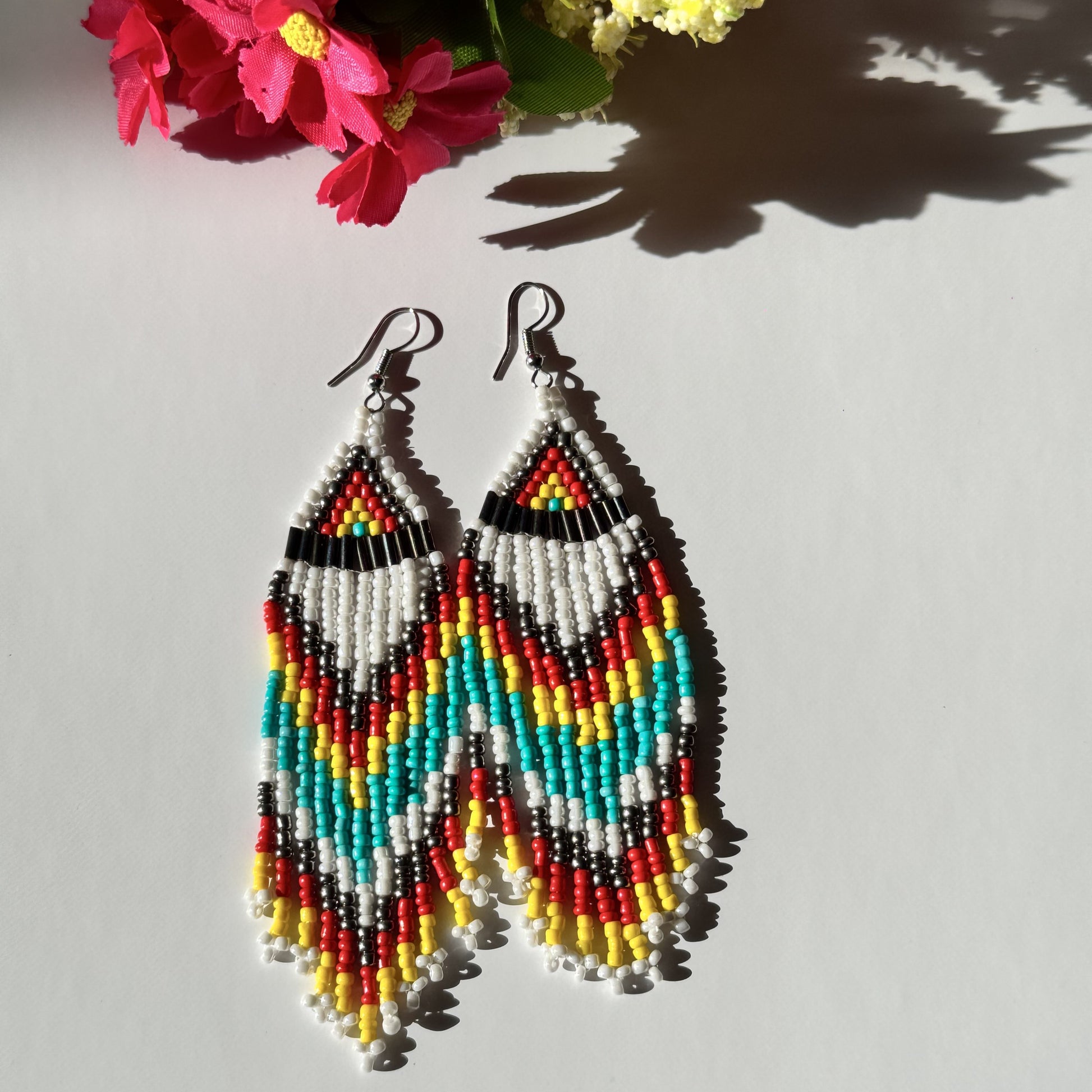 Elevate your style with these&nbsp;beaded earrings, a perfect blend of vibrant colors and intricate craftsmanship. Designed for bold, confident individuals, these statement earrings are inspired by traditional beadwork, featuring a chevron zigzag pattern that adds a unique artistic touch.