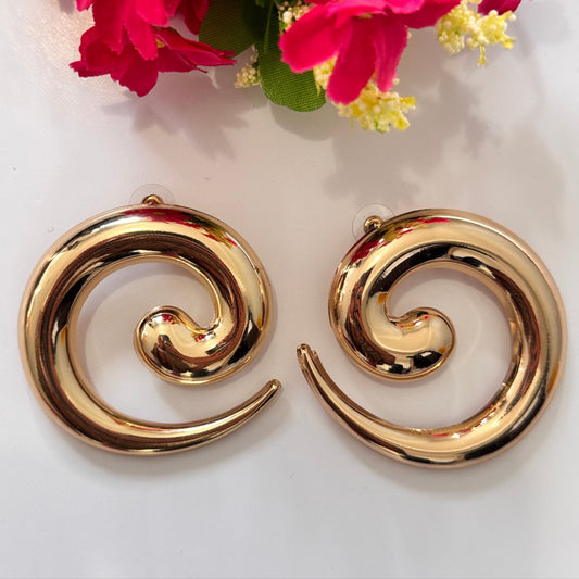 Unleash your inner goddess with these stunning Golden Swirl Statement Earrings, designed to make a lasting impression. Featuring a sleek, spiral silhouette with a high-shine gold finish, these earrings blend modern sophistication with artistic flair. 