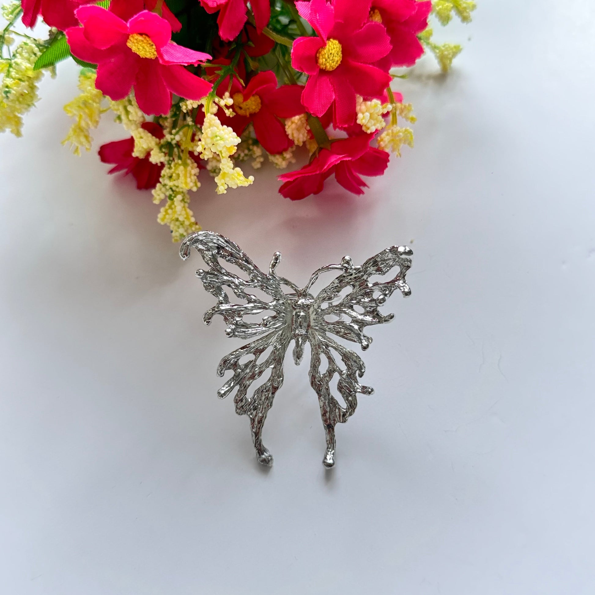 Elevate your style with this breathtaking silver butterfly statement adjustable ring, designed to captivate with its intricate details and bold presence. Crafted with a textured metal finish, this striking piece embodies grace, freedom, and transformation, making it the perfect accessory for those who love to express their individuality.
