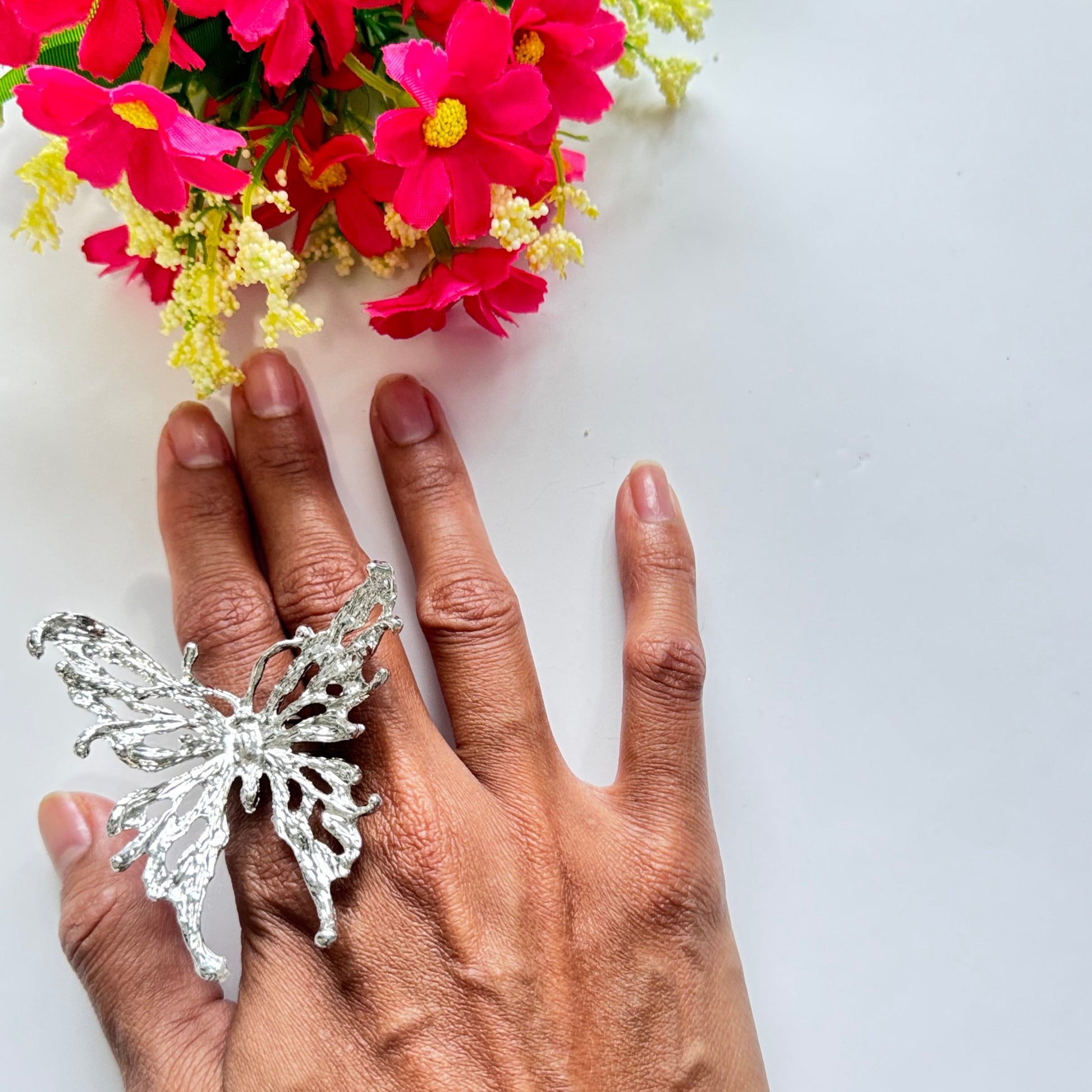 Elevate your style with this breathtaking silver butterfly statement adjustable ring, designed to captivate with its intricate details and bold presence. Crafted with a textured metal finish, this striking piece embodies grace, freedom, and transformation, making it the perfect accessory for those who love to express their individuality.