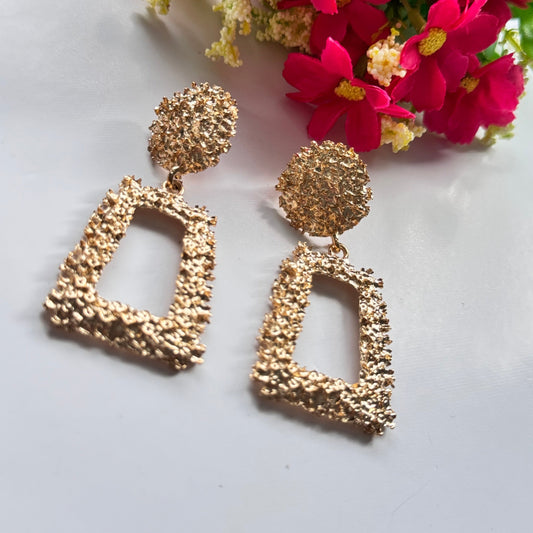 Elevate your style with these stunning gold-textured statement earrings, designed to make you shine effortlessly. Featuring an intricate crushed-metal design, these bold geometric dangle earrings add an instant touch of glamour to any outfit. The elegant open rectangle drop paired with a textured stud top creates a luxurious, modern appeal that catches the light beautifully with every movement.