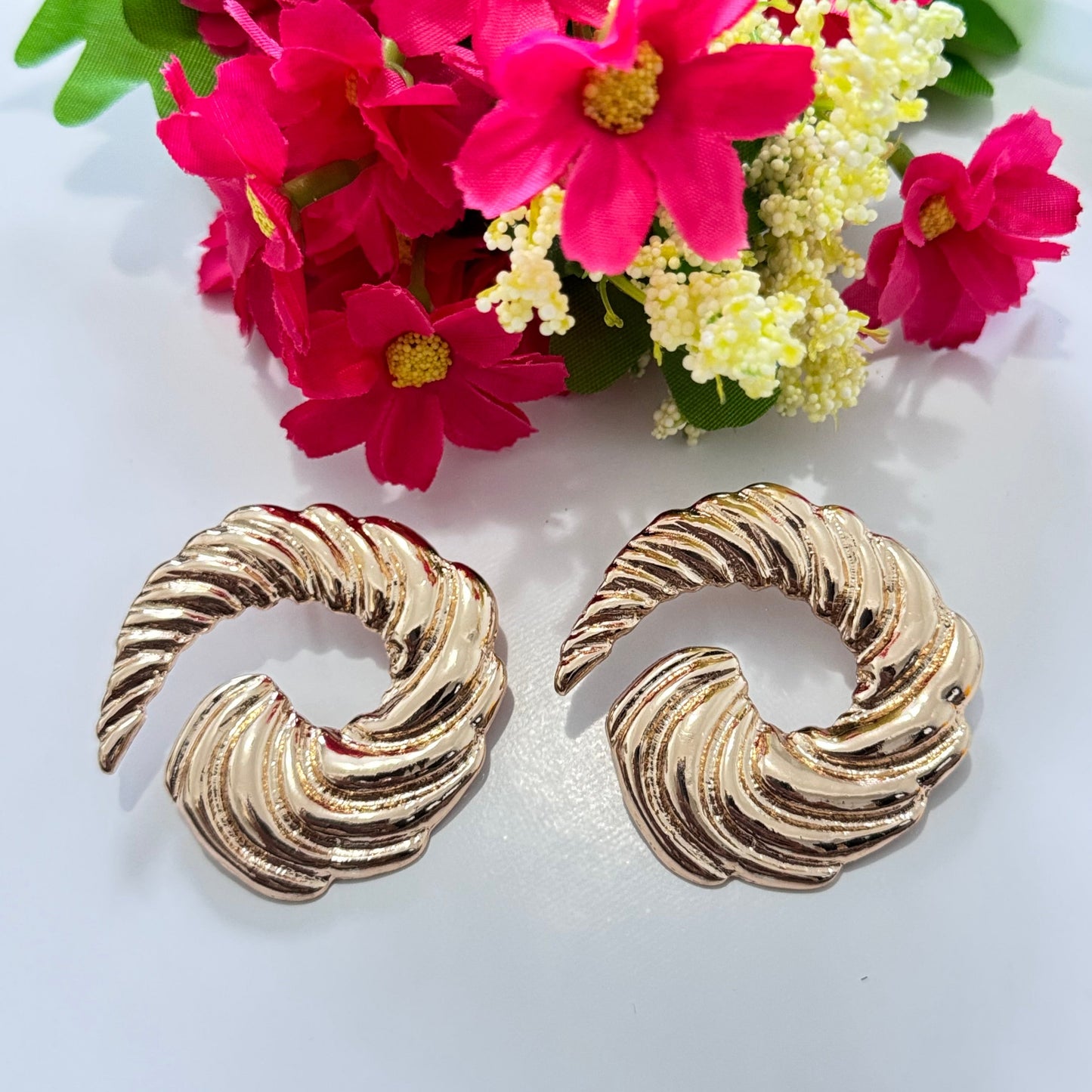 Designed with an elegant twisted spiral shape, these earrings exude classic glamour with a bold, contemporary edge. Their high-polish gold finish reflects light beautifully, making them the perfect statement piece for any occasion.