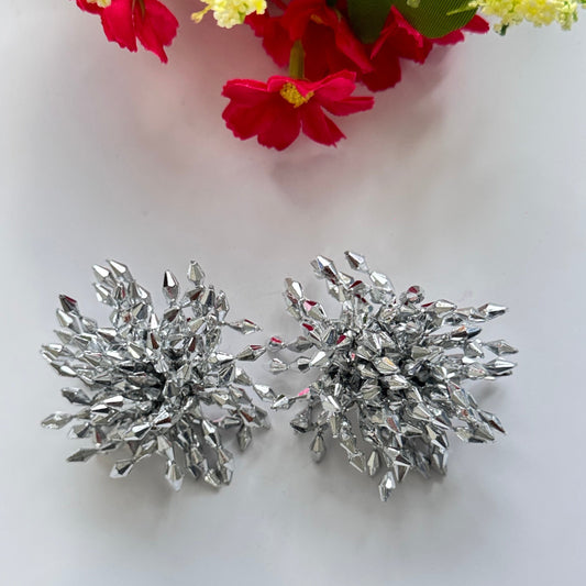 Introducing our Dazzling Crystal Burst Earrings – the epitome of elegance and bold glamour!These statement earrings feature a striking explosion of silver-toned crystals, intricately arranged to reflect light from every angle.