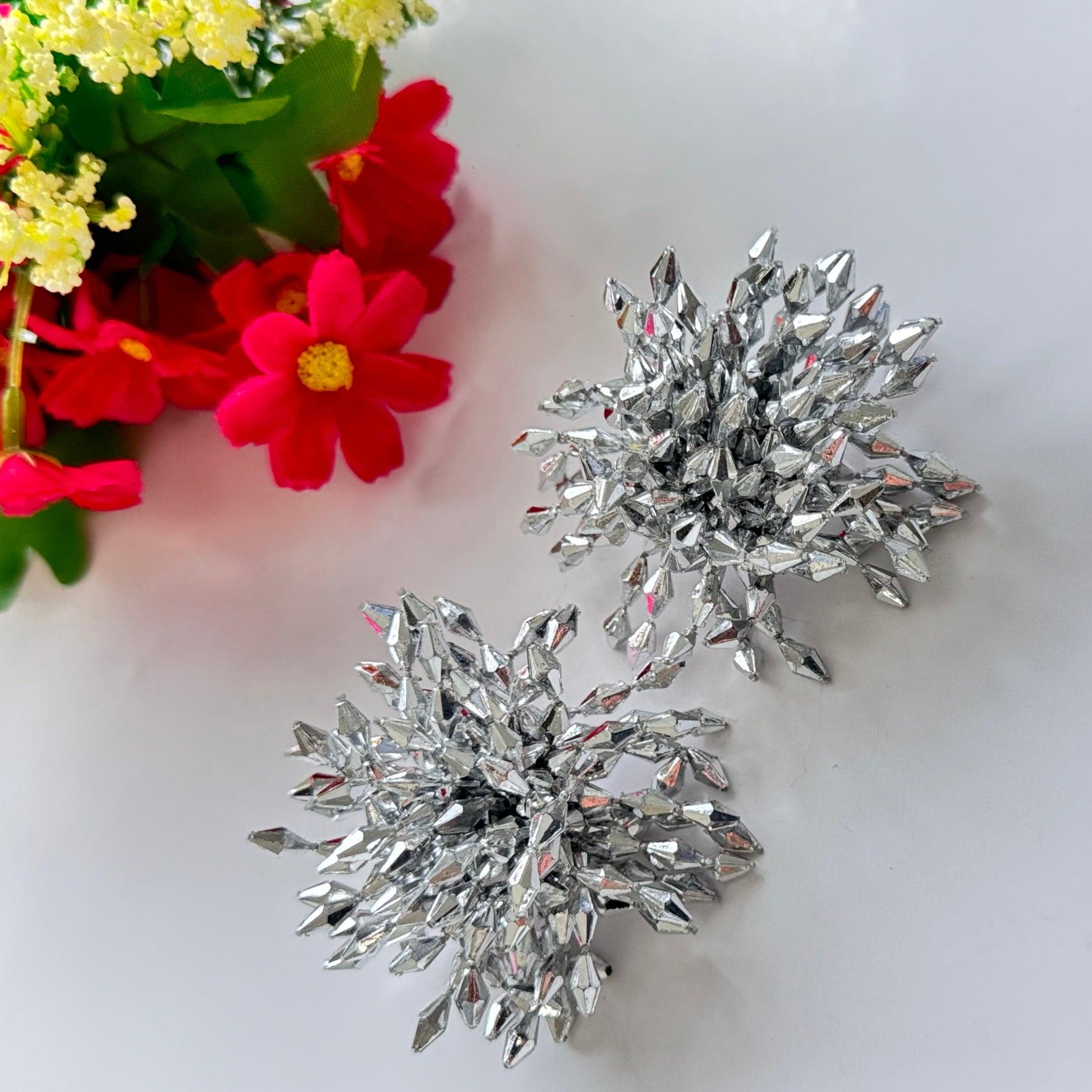 Introducing our Dazzling Crystal Burst Earrings – the epitome of elegance and bold glamour!These statement earrings feature a striking explosion of silver-toned crystals, intricately arranged to reflect light from every angle.