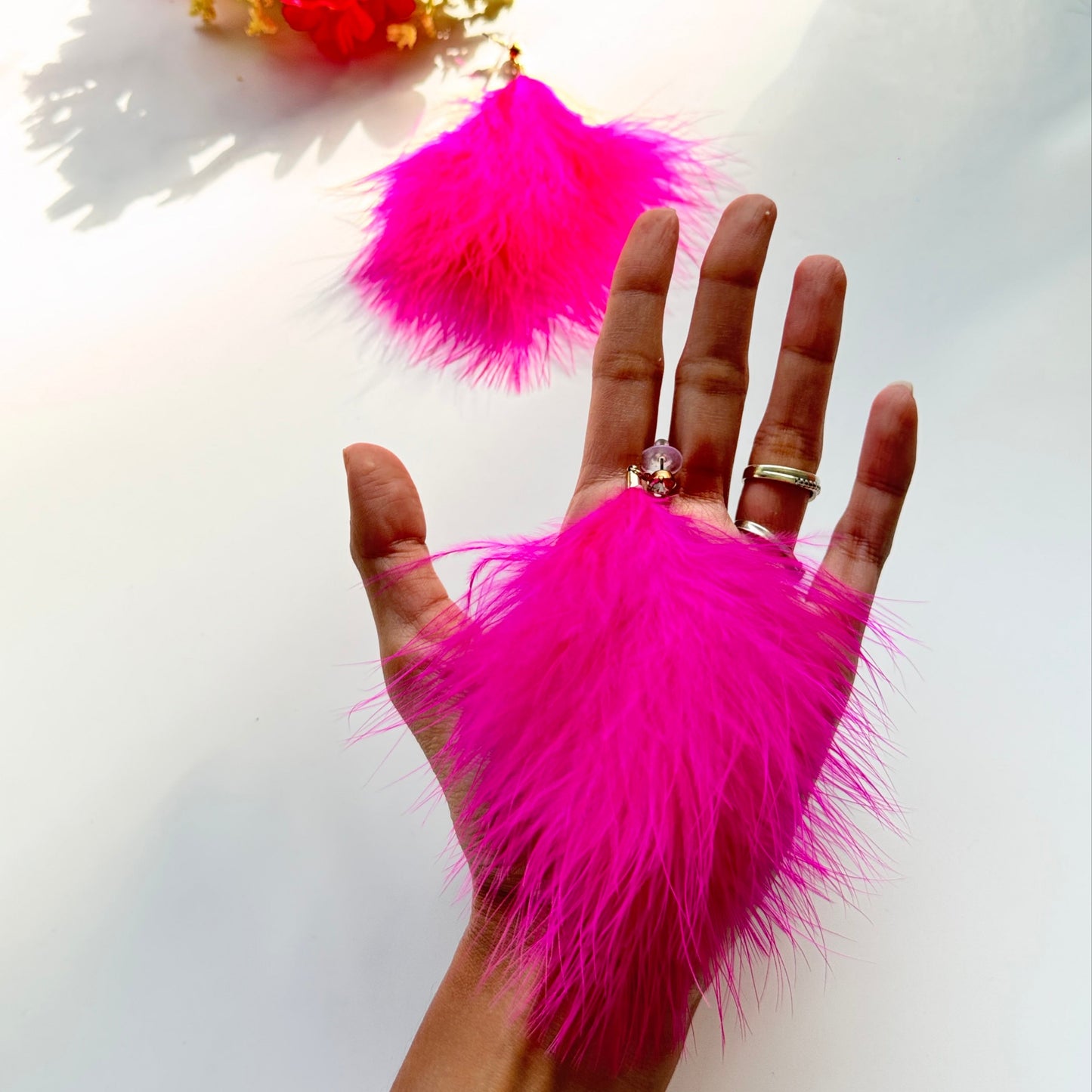 Turn heads and make a bold statement with these ultra-glamorous, hot pink feather earrings that redefine elegance with a touch of playful extravagance. Designed to add drama to any outfit, these lightweight, fluffy masterpieces sway effortlessly with every movement, catching the light and drawing attention wherever you go. The vibrant fuchsia hue radiates confidence, passion, and undeniable charm, making them the perfect choice for trendsetters who love to stand out.
