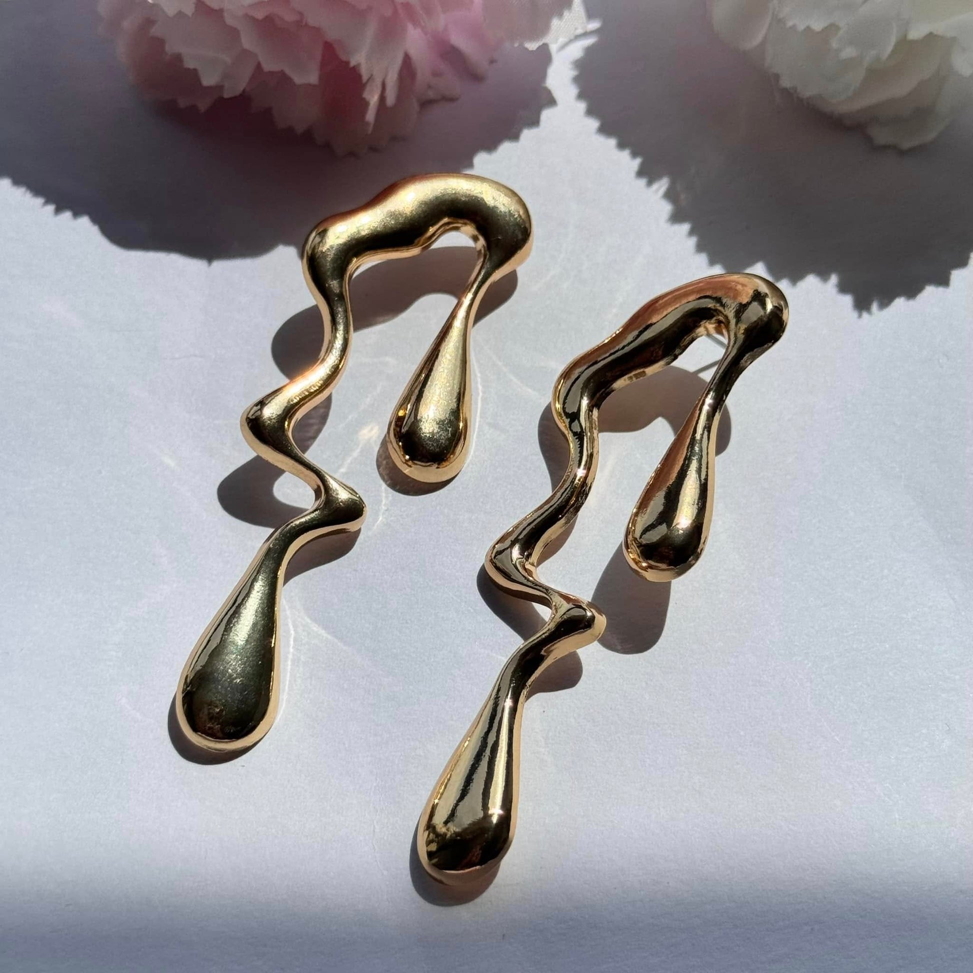 Sculptural earrings with a mesmerizing molten drip design—bold, artistic, and effortlessly chic. Perfect for making a statement!

Brand new
Available in silver and gold