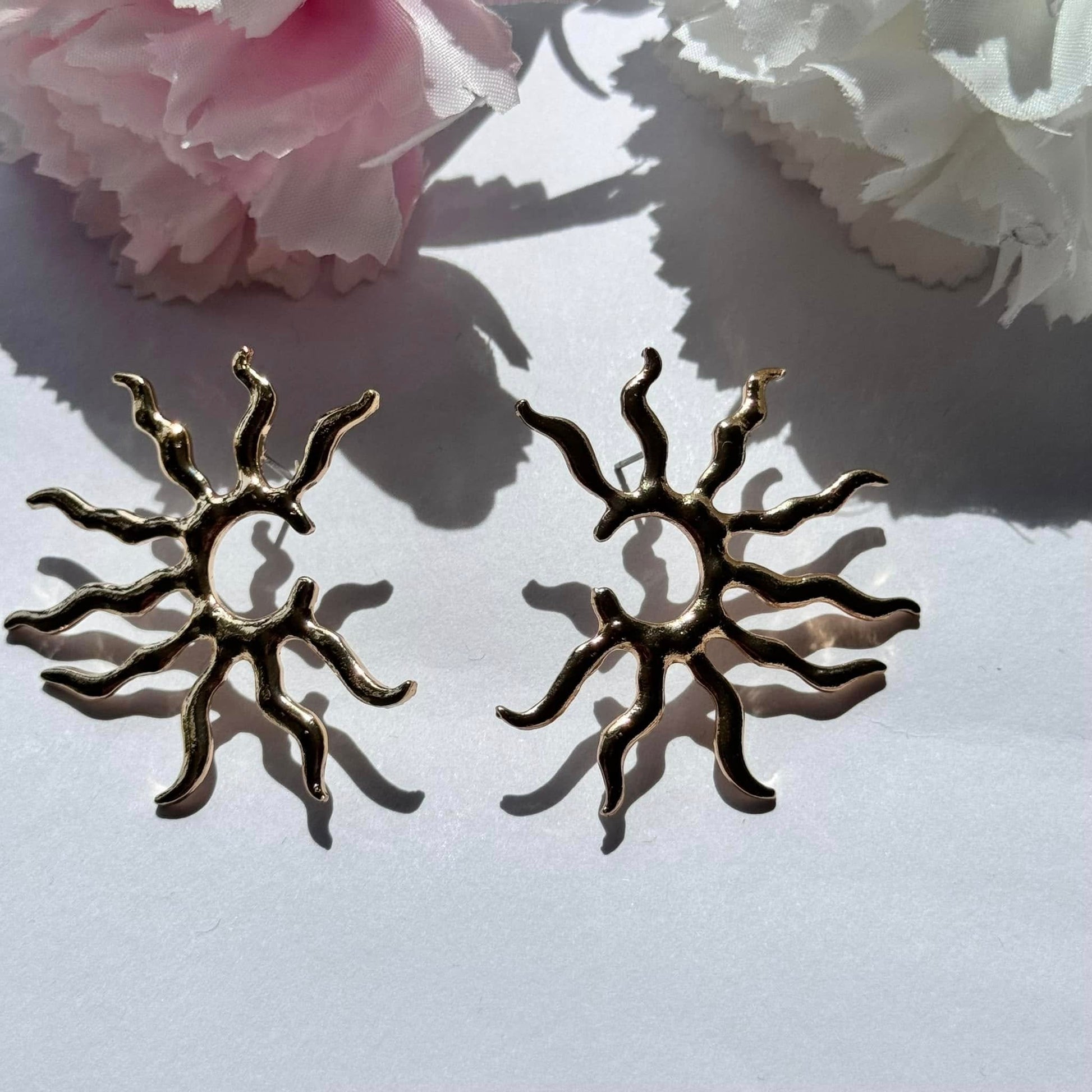 Radiate confidence with these gold sunburst statement earrings – a bold, celestial-inspired accessory for any occasion.