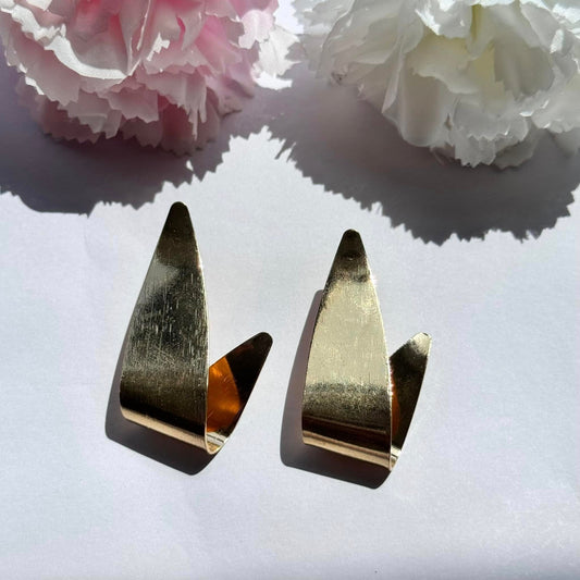 Bold and modern gold earrings – a statement piece that elevates any look with effortless elegance.