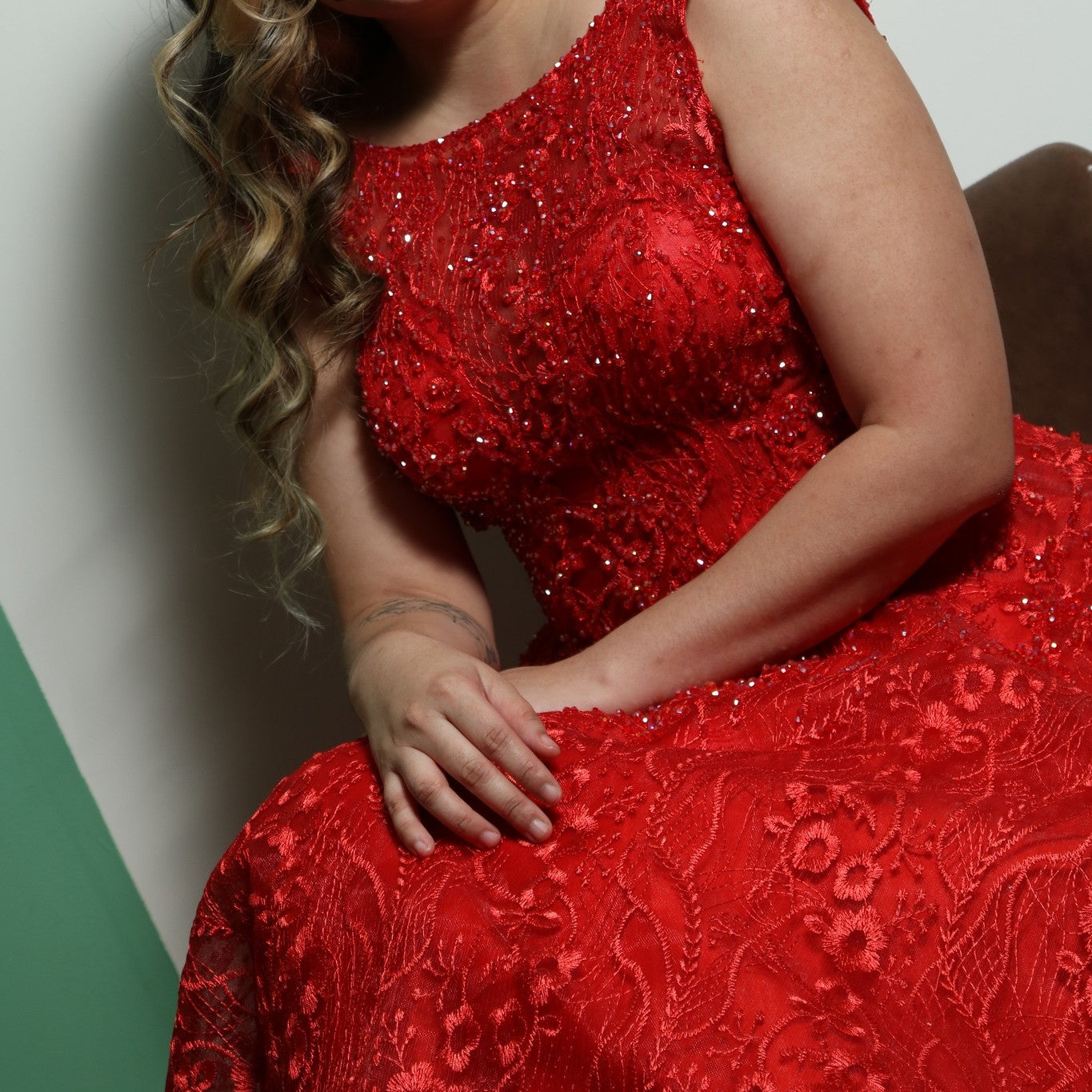 This dress is an elegant, floor-length red gown with intricate lace and beaded detailing. The design features a fitted bodice with cap sleeves and a voluminous skirt, creating a regal and dramatic silhouette. The heavy fabric and detailed embellishments add to its luxurious feel, making it suitable for formal events such as galas or weddings.
