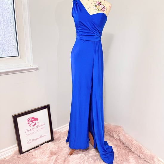 Step into elegance with this stunning cobalt blue one-shoulder gown, designed to turn heads at any special occasion. Featuring a flattering ruched bodice that accentuates your curves and a flowing floor-length silhouette with a dramatic side slit, this dress exudes confidence and sophistication. The soft, high-quality fabric drapes beautifully, creating an effortlessly chic look. 