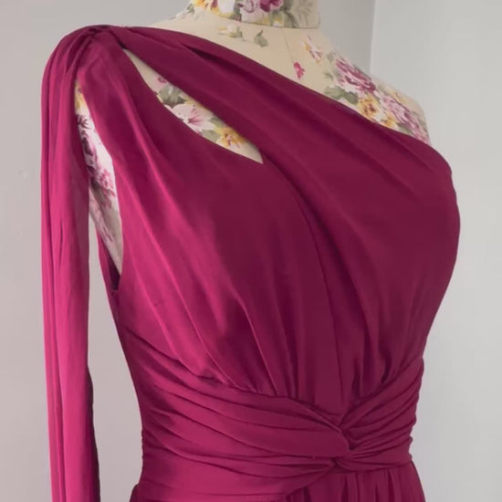 Elevate your wardrobe with this breathtaking one-shoulder gown in a deep wine hue, designed to make a statement at any formal event. Crafted from flowing chiffon, this dress drapes elegantly, featuring a cinched waist for a flattering silhouette and a striking sheer drape that adds an ethereal touch.
