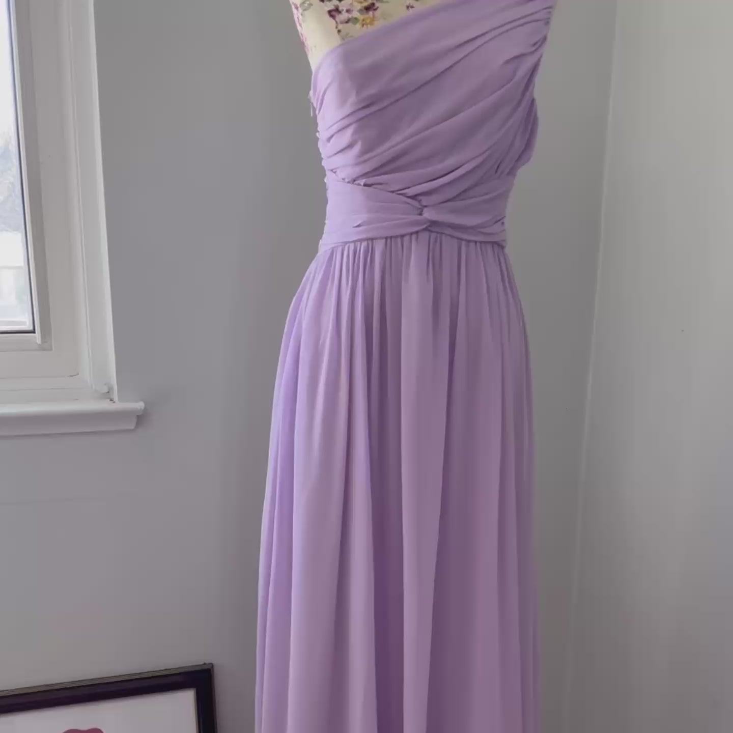 Turn heads in this breathtaking one-shoulder lavender gown, designed to make a statement at weddings, proms, and special occasions. Crafted with delicate pleated draping, a cinched waist for a flattering silhouette, and an elegant flowing skirt, this dress exudes timeless charm. Its soft, ethereal chiffon fabric creates a dreamy and romantic look.