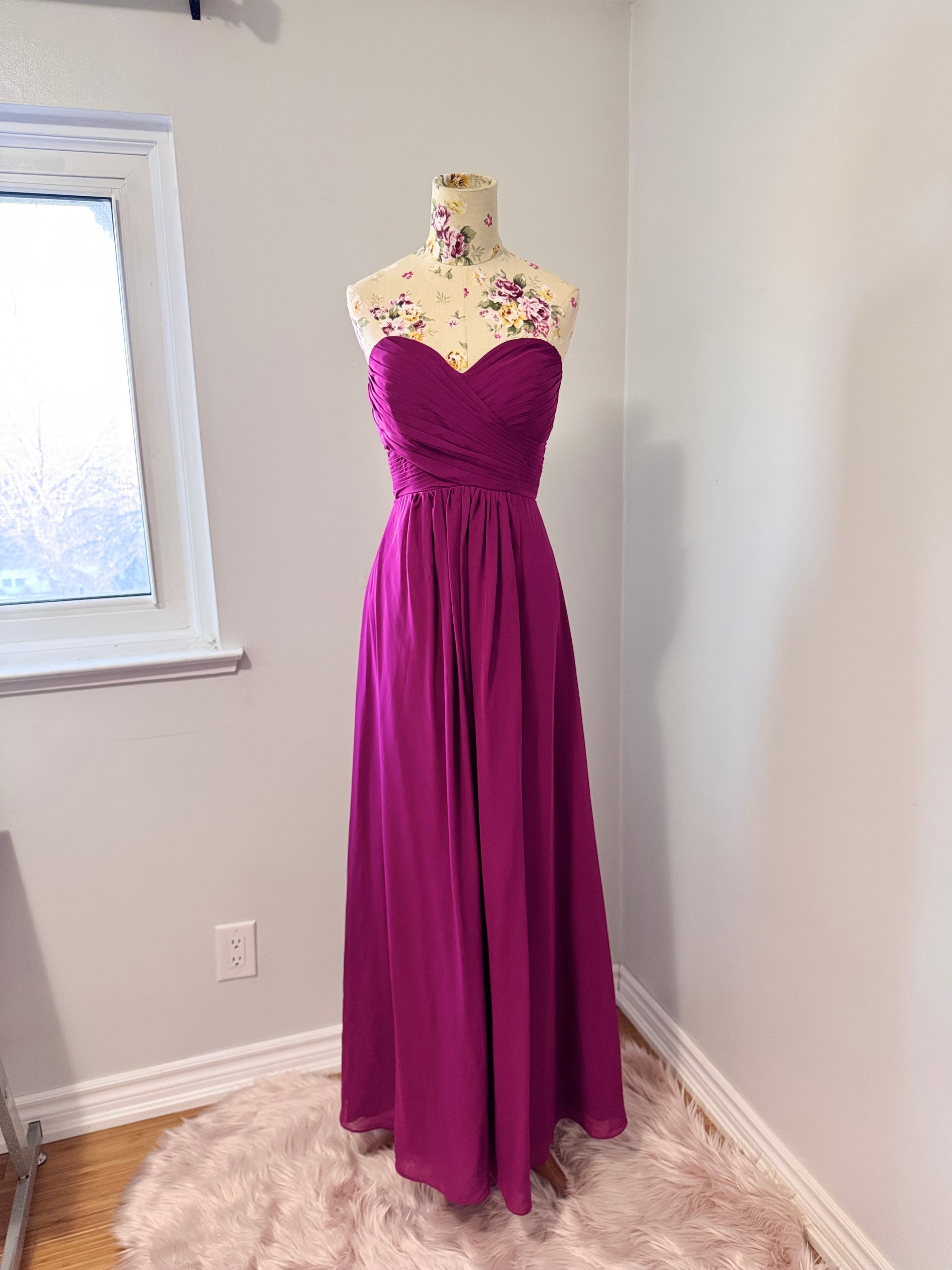 Make a statement in this breathtaking pre-owned, pristine-condition magenta gown, designed to turn heads at any formal event. Featuring a timeless sweetheart neckline with elegant ruched detailing, this floor-length dress flows effortlessly, creating a stunning silhouette that flatters every figure. The flowy chiffon fabric adds a touch of romance, perfect for weddings, galas, proms, or evening soirées. 