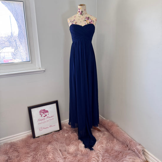 Elevate your elegance with this breathtaking navy-blue strapless evening gown, designed to make a statement at any special occasion. Featuring a flattering sweetheart neckline and a beautifully flowing chiffon skirt with a dramatic floor-length train, this dress exudes timeless sophistication. The structured bodice provides a secure fit, while the soft pleats add a touch of effortless charm. 
