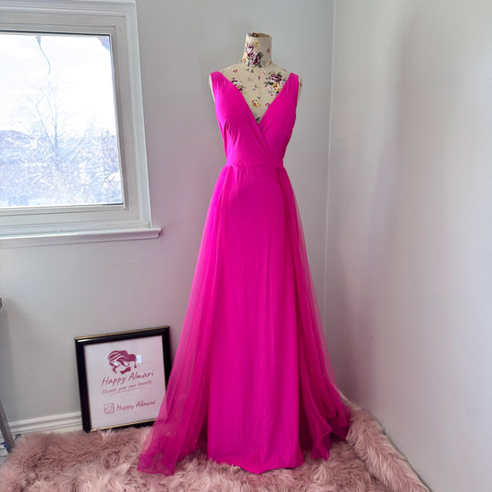 Turn heads and steal the spotlight in this breathtaking hot pink evening gown, designed to make every moment unforgettable. Featuring a stunning deep V-neckline and a flowing tulle overlay, this dress embodies elegance, confidence, and timeless charm. 