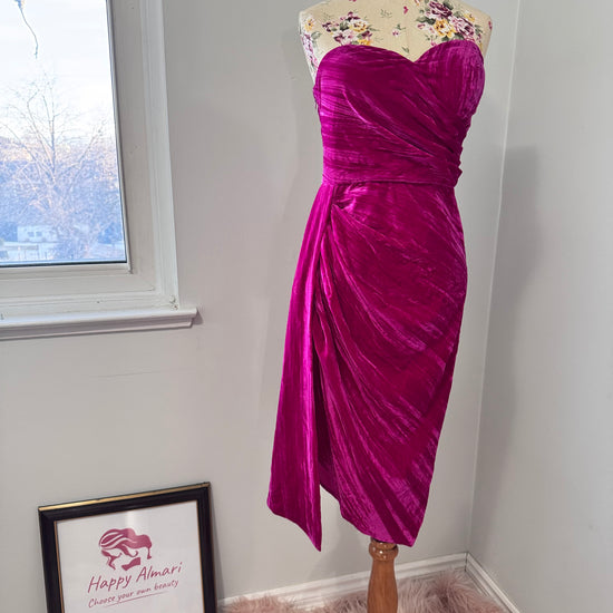 Turn heads in this stunning fuchsia velvet gown, designed to exude confidence and effortless glamour. Featuring a sculpted sweetheart neckline and expertly draped fabric that cinches at the waist, this dress enhances your natural silhouette with a flattering fit. The asymmetrical ruched detailing cascades into a flowing side drape, adding movement and dimension for a show-stopping effect.