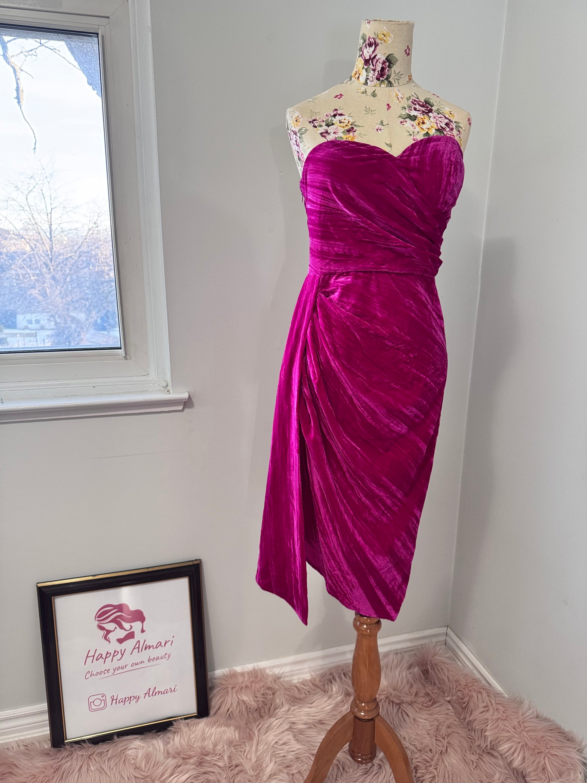 Turn heads in this stunning fuchsia velvet gown, designed to exude confidence and effortless glamour. Featuring a sculpted sweetheart neckline and expertly draped fabric that cinches at the waist, this dress enhances your natural silhouette with a flattering fit. The asymmetrical ruched detailing cascades into a flowing side drape, adding movement and dimension for a show-stopping effect.