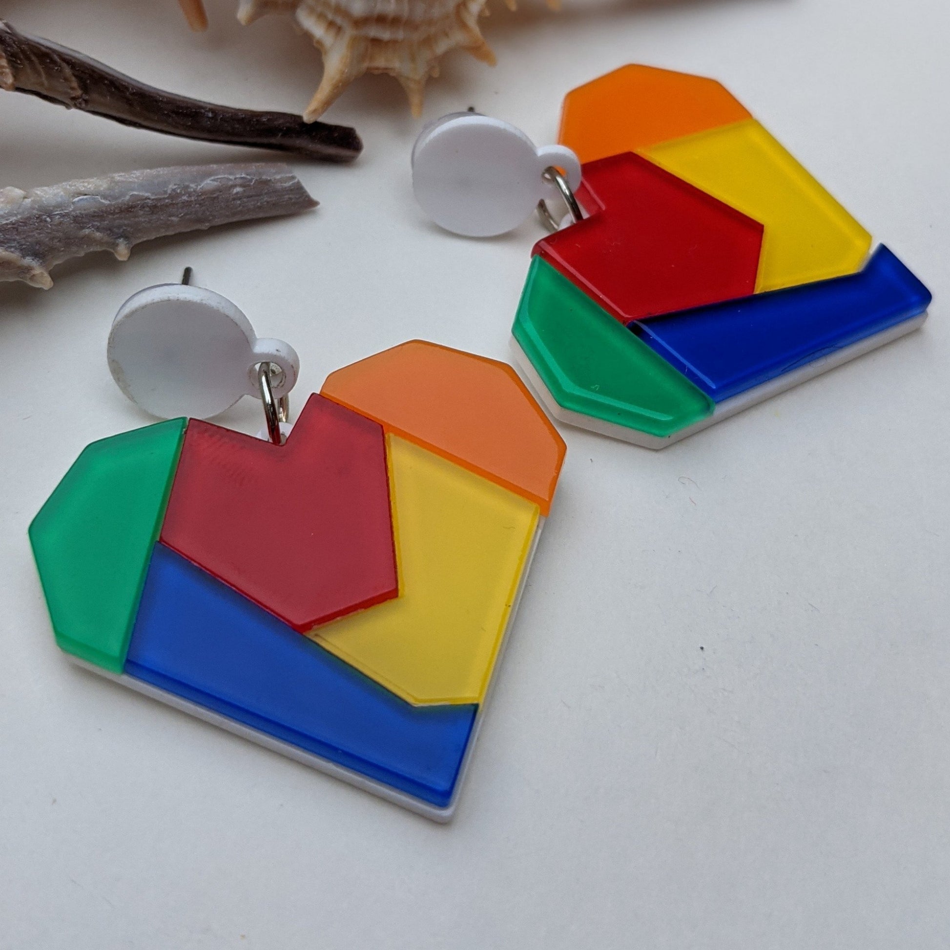 These rainbow, vibrant mosaic earrings are lightweight statement pieces that are perfect for any occasion. Whether you're attending a festival, enjoying a beach day, or simply adding everyday flair, they'll add a playful pop of color to your look.