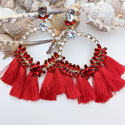 Introducing our Radiance Statement Earrings – a bold and breathtaking earring available in Red, Yellow, Green, and Pink! These eye-catching earrings feature sparkling crystal-studded hoops, vibrant gemstone embellishments, and elegant silk tassels that add a touch of movement and drama. Designed for the fearless fashionista whether you choose fiery red, sunshine yellow, emerald green, or blush pink, each color is crafted to make a stunning statement.