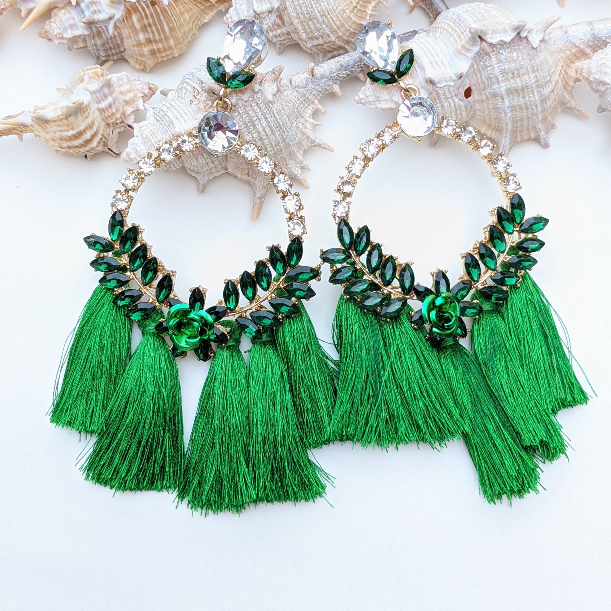 Introducing our Radiance Statement Earrings – a bold and breathtaking earring available in Red, Yellow, Green, and Pink! These eye-catching earrings feature sparkling crystal-studded hoops, vibrant gemstone embellishments, and elegant silk tassels that add a touch of movement and drama. Designed for the fearless fashionista whether you choose fiery red, sunshine yellow, emerald green, or blush pink, each color is crafted to make a stunning statement.