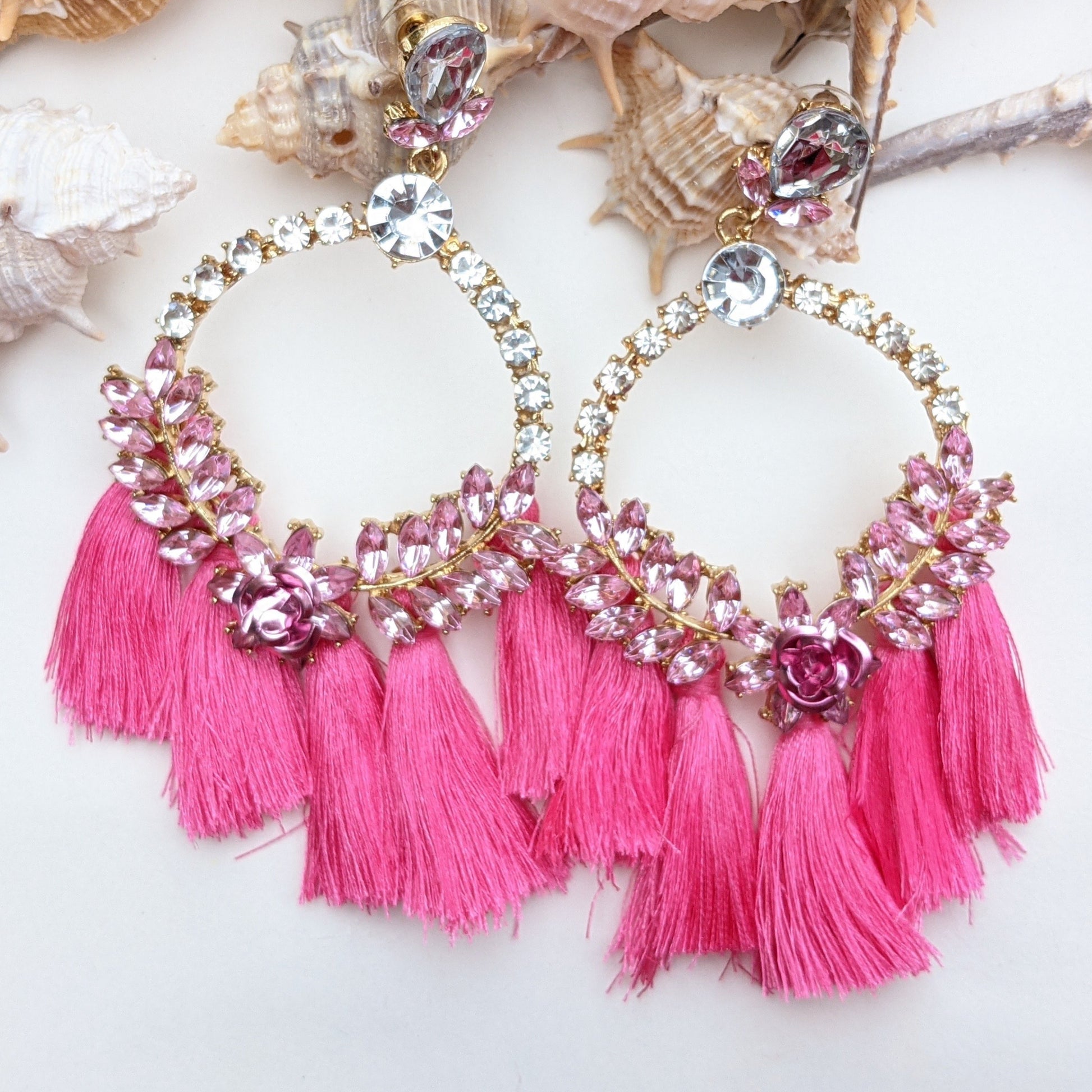 Introducing our Radiance Statement Earrings – a bold and breathtaking earring available in Red, Yellow, Green, and Pink! These eye-catching earrings feature sparkling crystal-studded hoops, vibrant gemstone embellishments, and elegant silk tassels that add a touch of movement and drama. Designed for the fearless fashionista whether you choose fiery red, sunshine yellow, emerald green, or blush pink, each color is crafted to make a stunning statement.