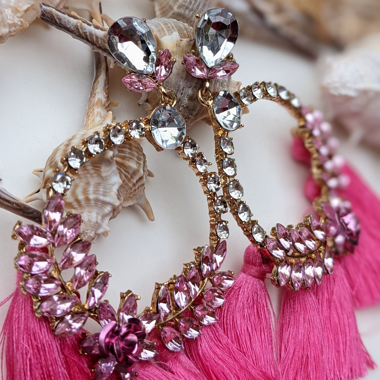 Introducing our Radiance Statement Earrings – a bold and breathtaking earring available in Red, Yellow, Green, and Pink! These eye-catching earrings feature sparkling crystal-studded hoops, vibrant gemstone embellishments, and elegant silk tassels that add a touch of movement and drama. Designed for the fearless fashionista whether you choose fiery red, sunshine yellow, emerald green, or blush pink, each color is crafted to make a stunning statement.