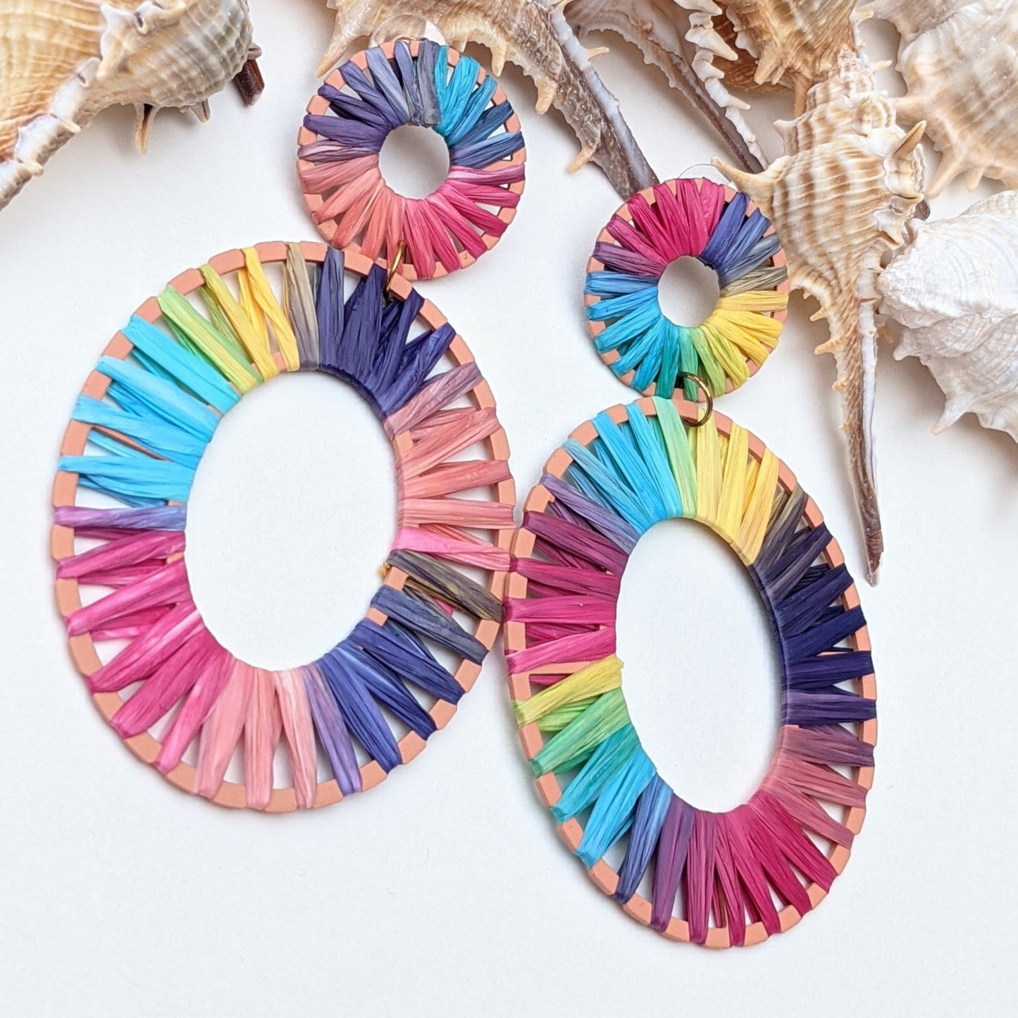 Add a vibrant pop of color to your look with these rainbow raffia hoop earrings – lightweight and bold 🌈✨ Shop now for a unique statement piece!