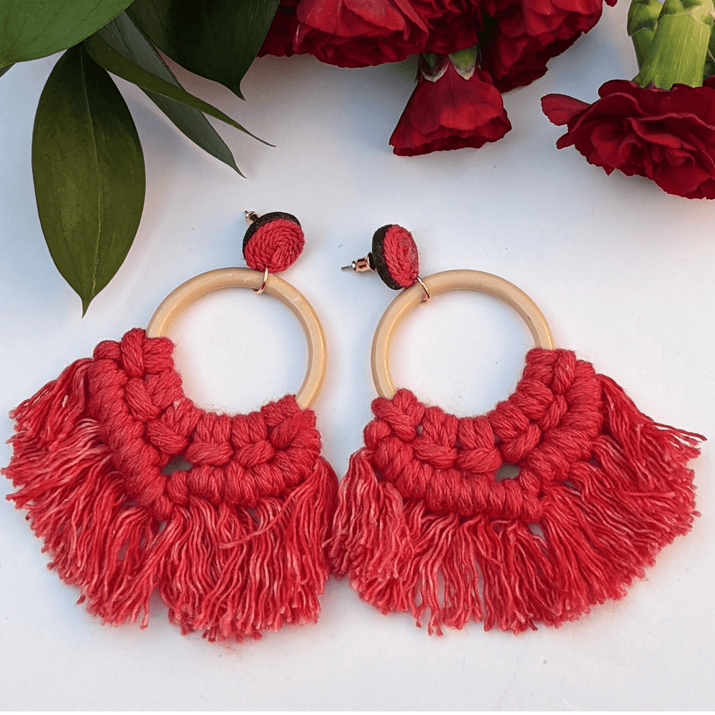 Boho-chic red macramé hoop earrings with wooden accents—perfect for a bold, statement look.