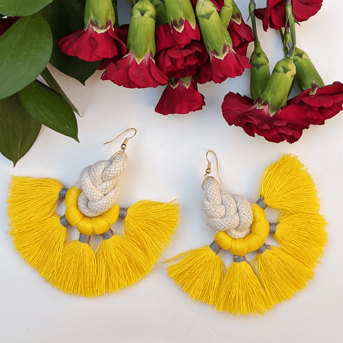Bold and vibrant yellow tassel earrings with intricate rope detailing—perfect for adding a playful yet chic touch to any outfit.