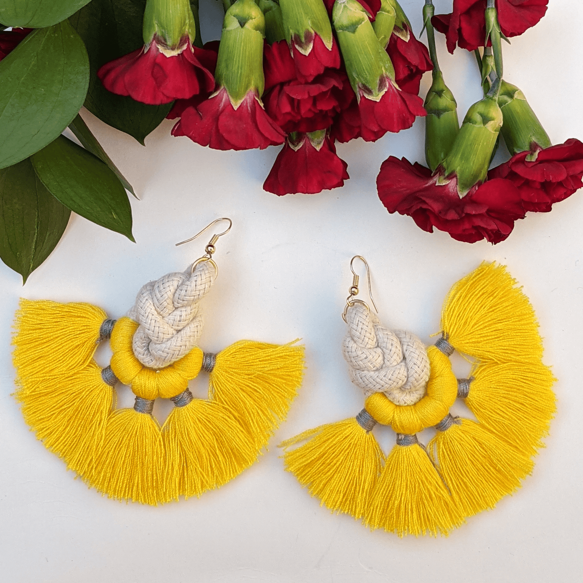 Bold and vibrant yellow tassel earrings with intricate rope detailing—perfect for adding a playful yet chic touch to any outfit.