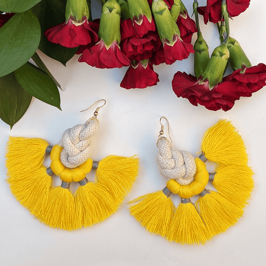 Bold and vibrant yellow tassel earrings with intricate rope detailing—perfect for adding a playful yet chic touch to any outfit.